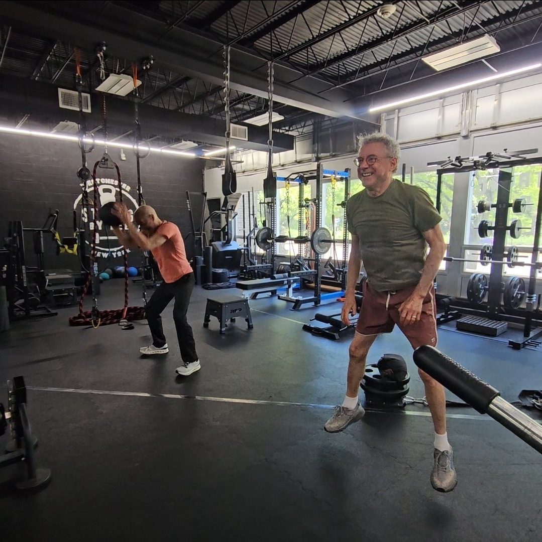 Client laughing during training session at Strong by Lee