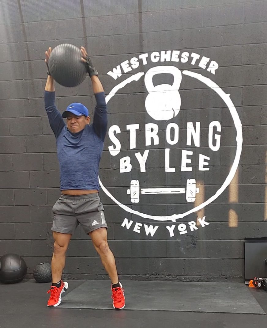 Client overhead press at Strong by Lee